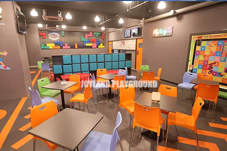 Indoor playground restaurant area with comfortable seating for families.