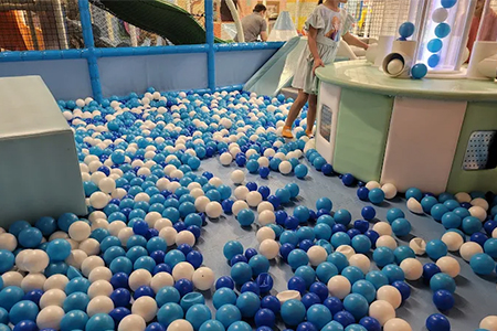 Children enjoying a fun and vibrant ball pit in an indoor playground.