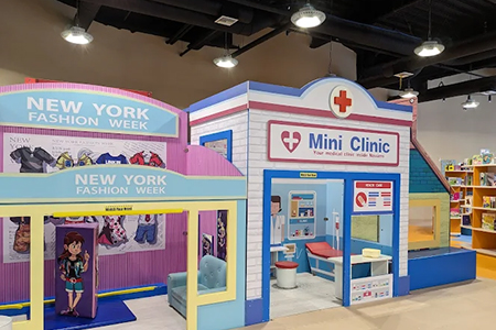 Children participating in role-play activities in a themed playhouse.