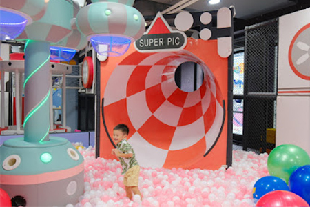 Interactive ball cannon game in indoor playground equipment for home commercial venues.