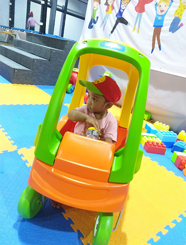 Toddler pedal cars in an indoor playground built in India, offering mobility and fun.